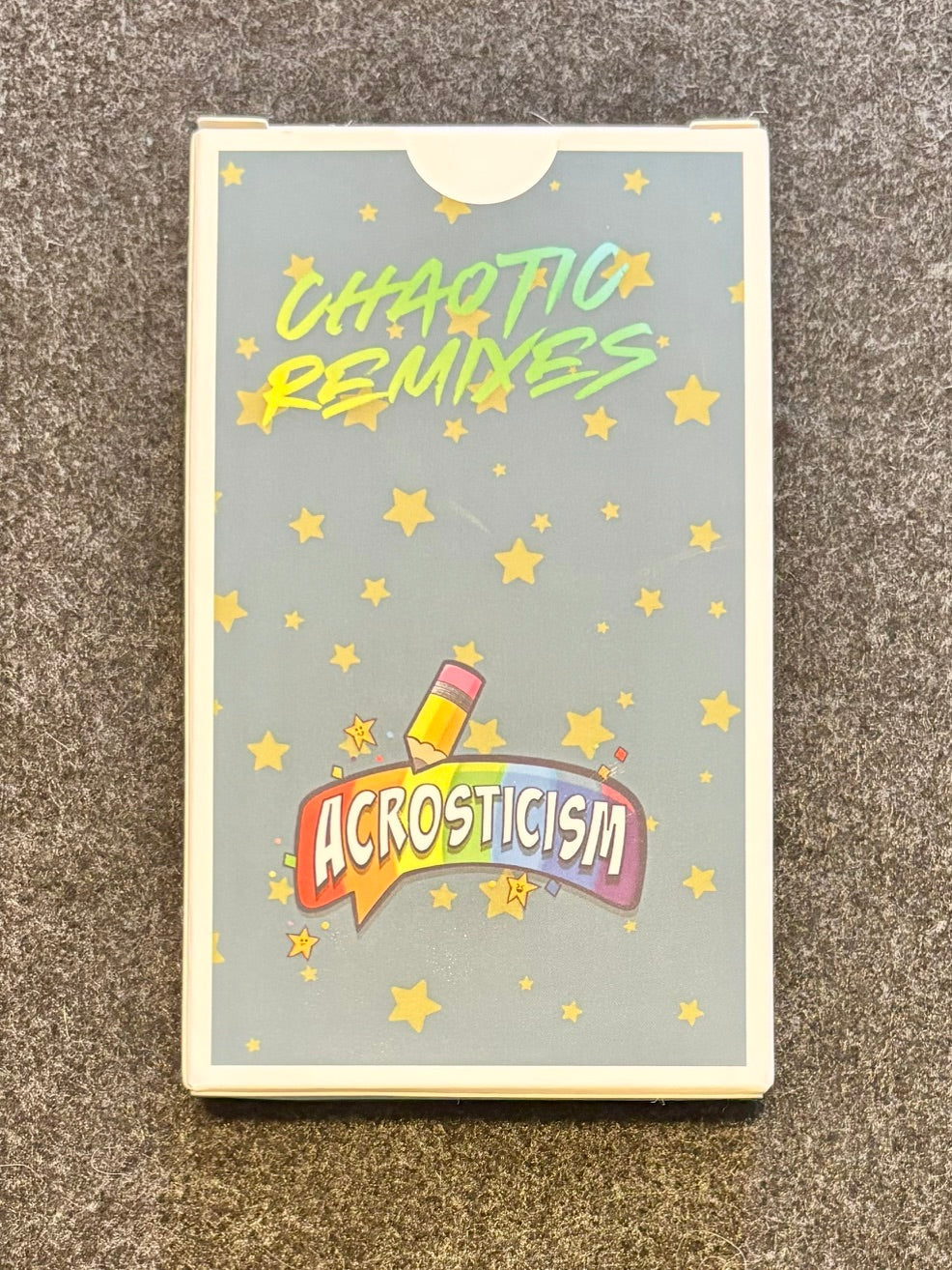 Chaotic Remixes expansion box with Acrosticism rainbow logo and star pattern